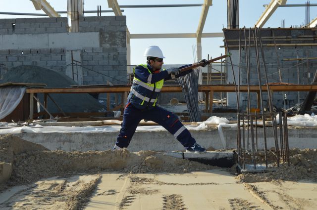Safety Construction Vest - man standing near rods