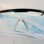 Safety Goggles - black framed eyeglasses on white textile