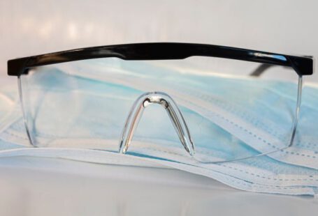 Safety Goggles - black framed eyeglasses on white textile