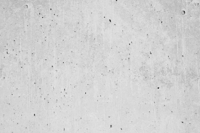Concrete Mixers - a black and white photo of a concrete wall