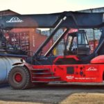Loader - Red and Black Front-loader Beside Intermodal Containers