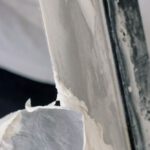 Concrete Trowels - Crop unrecognizable male in gloves holding putty knives while working at new home