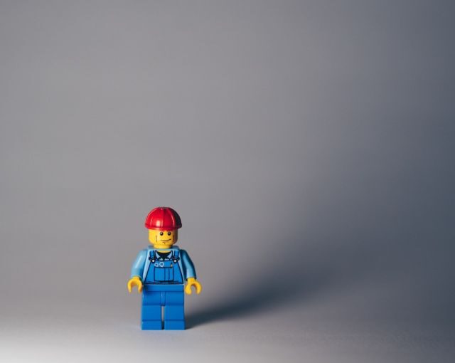Builder - lego minifig on white surface