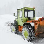 Bulldozer - Green and Orange Snow Tractor on Snow Covered Ground