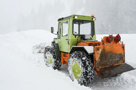 Bulldozer - Green and Orange Snow Tractor on Snow Covered Ground