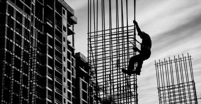Construction Workers - Silhouette of Man Holding onto Metal Frame