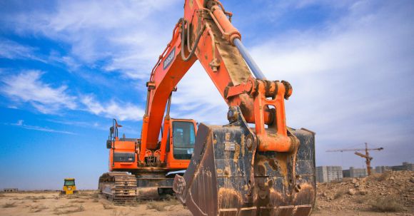 Heavy Construction Equipment - Low Angle Photography of Orange Excavator Under White Clouds