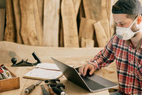 Construction Tools - Man Using a Laptop at a Wood Workshop