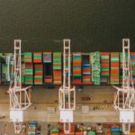 Heavy Construction Equipment - Colorful cargo containers on ship near pier