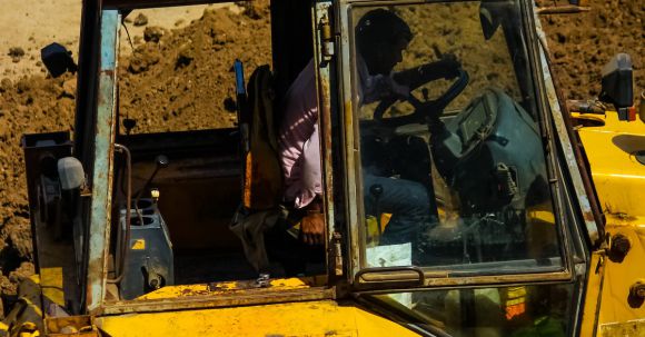 Bulldozer - Man Driving a Yellow Heavy Equipment