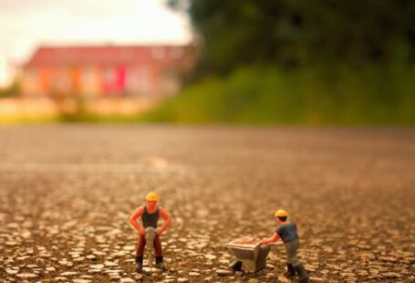 Construction Workers - Selective Focus Photography of Two Men Builder Figurines