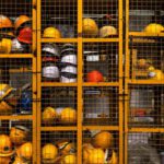 Safety Construction Vest - a rack filled with lots of yellow hard hats