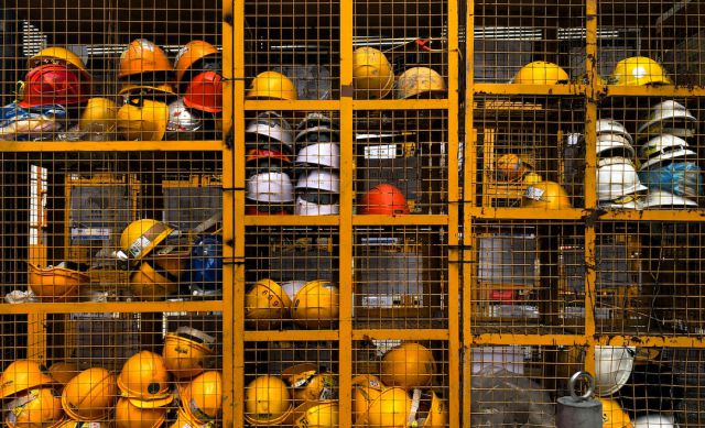 Safety Construction Vest - a rack filled with lots of yellow hard hats