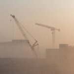 Construction - Cranes Near Building during Sunset