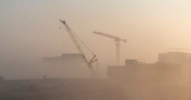Construction - Cranes Near Building during Sunset