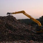 Excavator - Excavator on Work on a Landfill