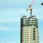 Heavy Construction Equipment - Beige Concrete High-rise Building