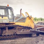 Bulldozer - Yellow and Brown Metal Pay Loader on He Dirt