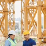 Construction - A Man and a Woman Wearing Personal Protective Clothing