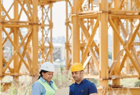 Construction - A Man and a Woman Wearing Personal Protective Clothing