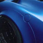 Construction Industry - High angle of tire and back window of fashioned expensive blue coupe car parked in garage