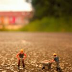 Construction Workers - Selective Focus Photography of Two Men Builder Figurines