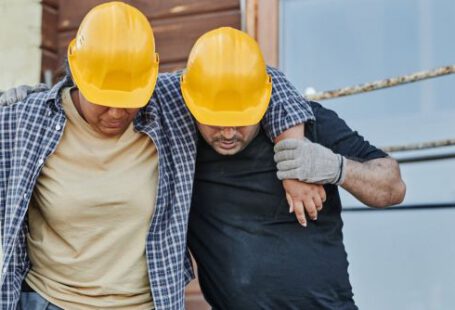 Construction Workers - A Worker Supporting an Injured Co-Worker