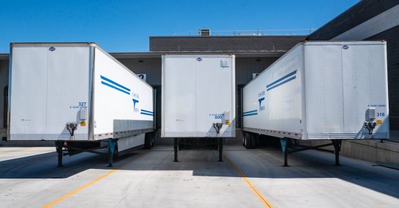 Building Industry - Three White Enclosed Trailers