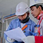 Construction - Two Man Holding White Paper