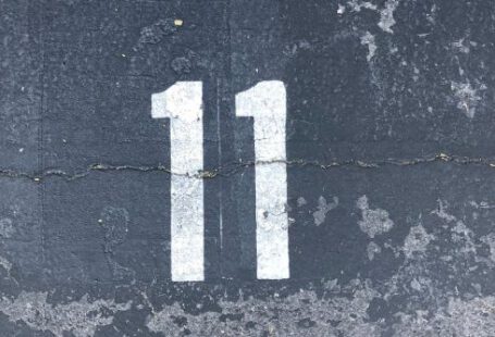 Cement - Person Standing On Concrete Floor With Number 11 Paint