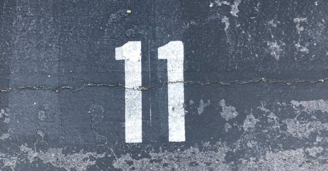 Cement - Person Standing On Concrete Floor With Number 11 Paint