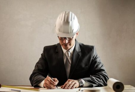Hardhat - Professional architect working with draft in office