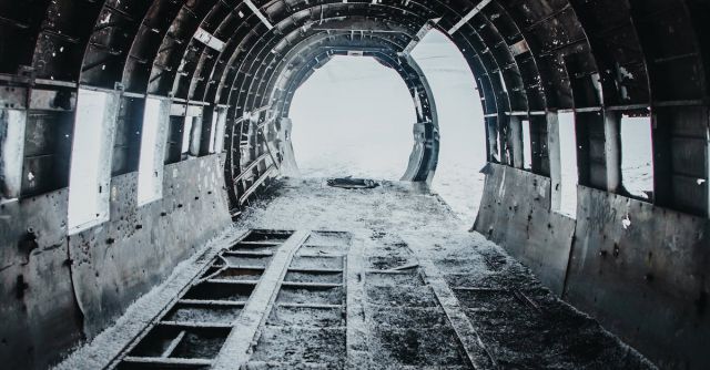 Construction Industry - Disused old grey aircraft with snow on floor