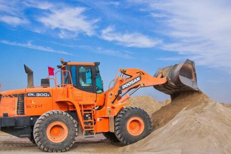 Heavy Construction Equipment - Orange Excavator on Brown Hill