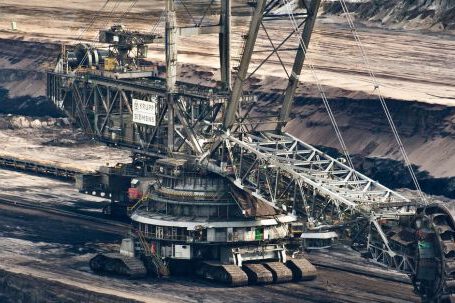Excavator - Silver Steel Mining Crane on Black Rocky Soil during Daytime