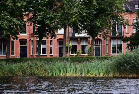 Building Industry - a red brick building next to a body of water