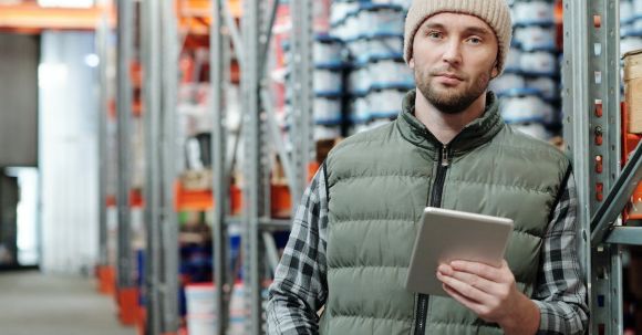 Loader - Man in Bubble Jacket Holding White Tablet Computer