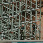Construction Workers - Two Person on Truss Tower