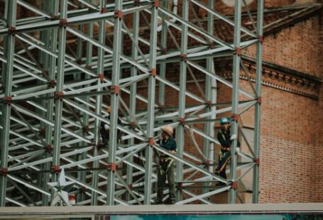 Construction Workers - Two Person on Truss Tower