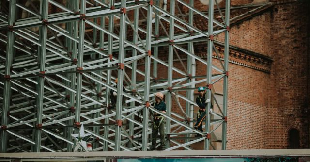 Construction Workers - Two Person on Truss Tower
