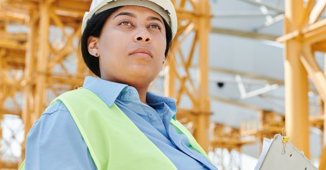 Safety Construction Vest - Woman Wearing Helmet and Safety Vest